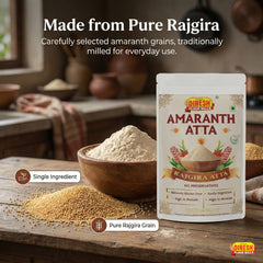 Dinesh Flour Mills Amaranth Atta package with amaranth grains and flour on a wooden surface.
