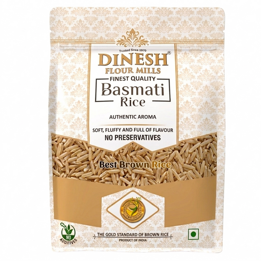 A stand-up pouch of Dinesh Flour Mills Basmati Rice on a plain white background. The packaging is cream and gold with a damask pattern, featuring a clear window showing the brown rice grains inside.
