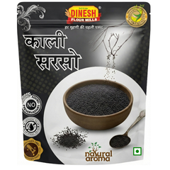 A stand-up pouch of Dinesh Flour Mills Kalli Sarso (black sesame) against a white background. The packaging is primarily black and white, featuring a central graphic of a brown bowl filled with black sesame seeds, a spoon with seeds, and Hindi text.