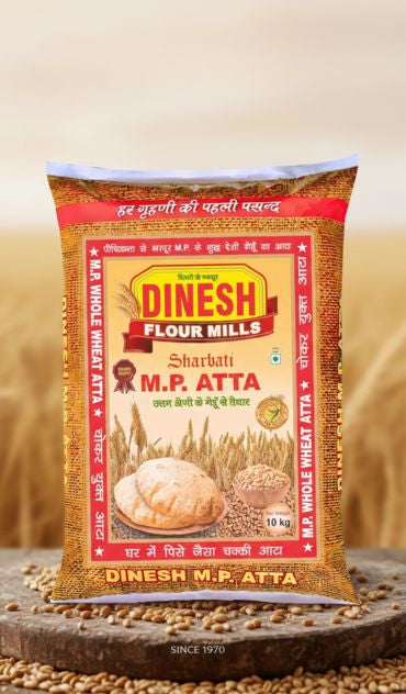 Dinesh Flour Mills M.P. Atta packaging on a wooden surface with wheat in the background