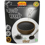 A stand-up pouch of Dinesh Flour Mills Kalli Sarso (black sesame) against a white background. The packaging is primarily black and white, featuring a central graphic of a brown bowl filled with black sesame seeds, a spoon with seeds, and Hindi text.
