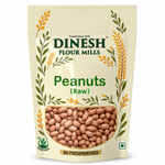 A stand-up pouch of Dinesh Flour Mills Raw Peanuts on a plain white background. The packaging is cream-colored with green and yellow illustrations of wheat stalks, featuring a clear window that displays the raw peanuts inside.