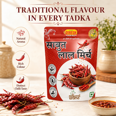 A red stand-up pouch of Dinesh Rawal's 'Saubhah Lal Mirch' (Saturday Red Chili) spice mix, displayed on a light beige background with decorative props including loose red chilies, a bowl of chili paste, and ceramic jars. The image includes marketing text overlays and circular icons highlighting natural aroma, rich color, and distinct chili taste.