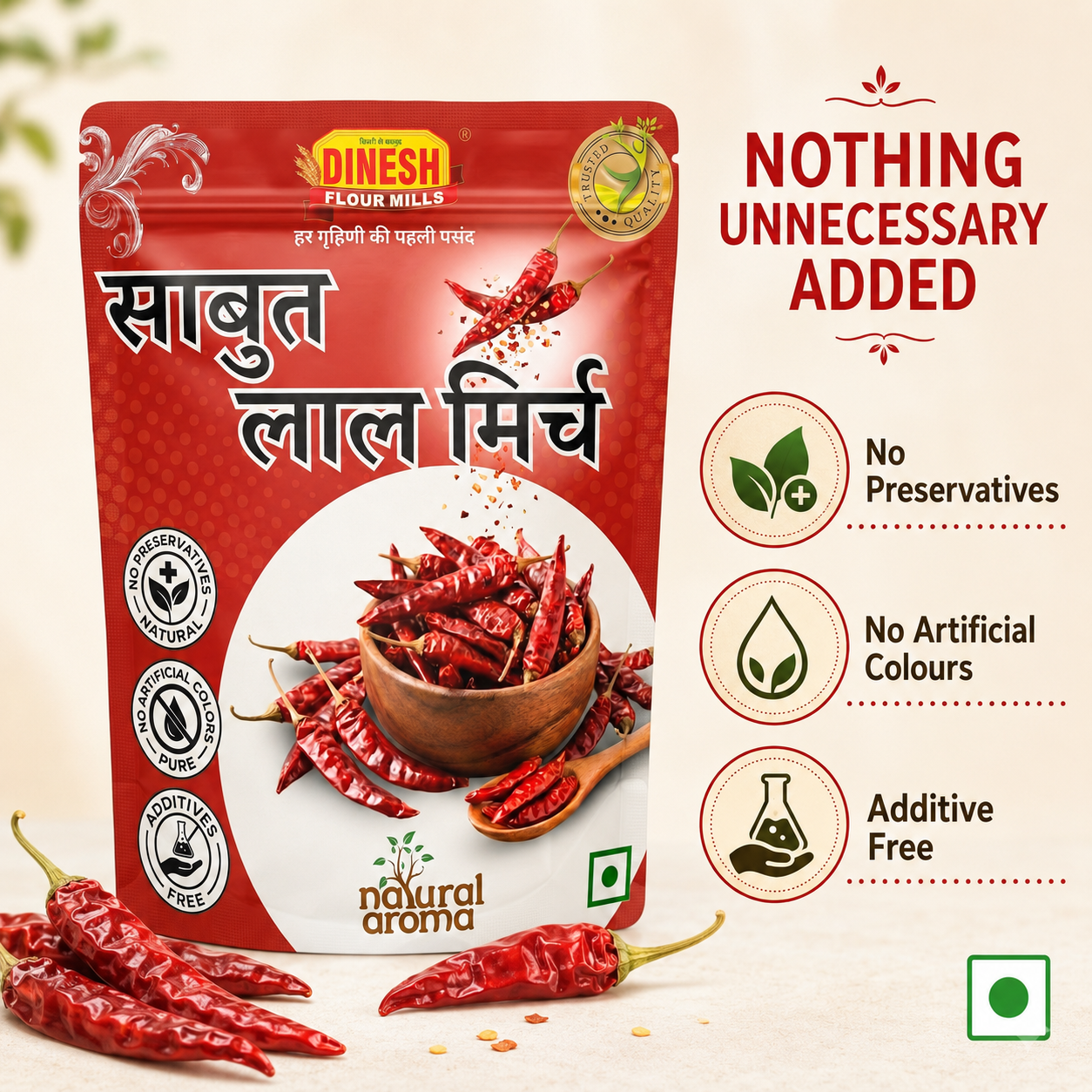 A package of Dinesh Flour Mills Sabut Lal Mirch (red chili powder) shown on a light beige background with decorative red chili peppers and text highlighting its natural, additive-free qualities.
