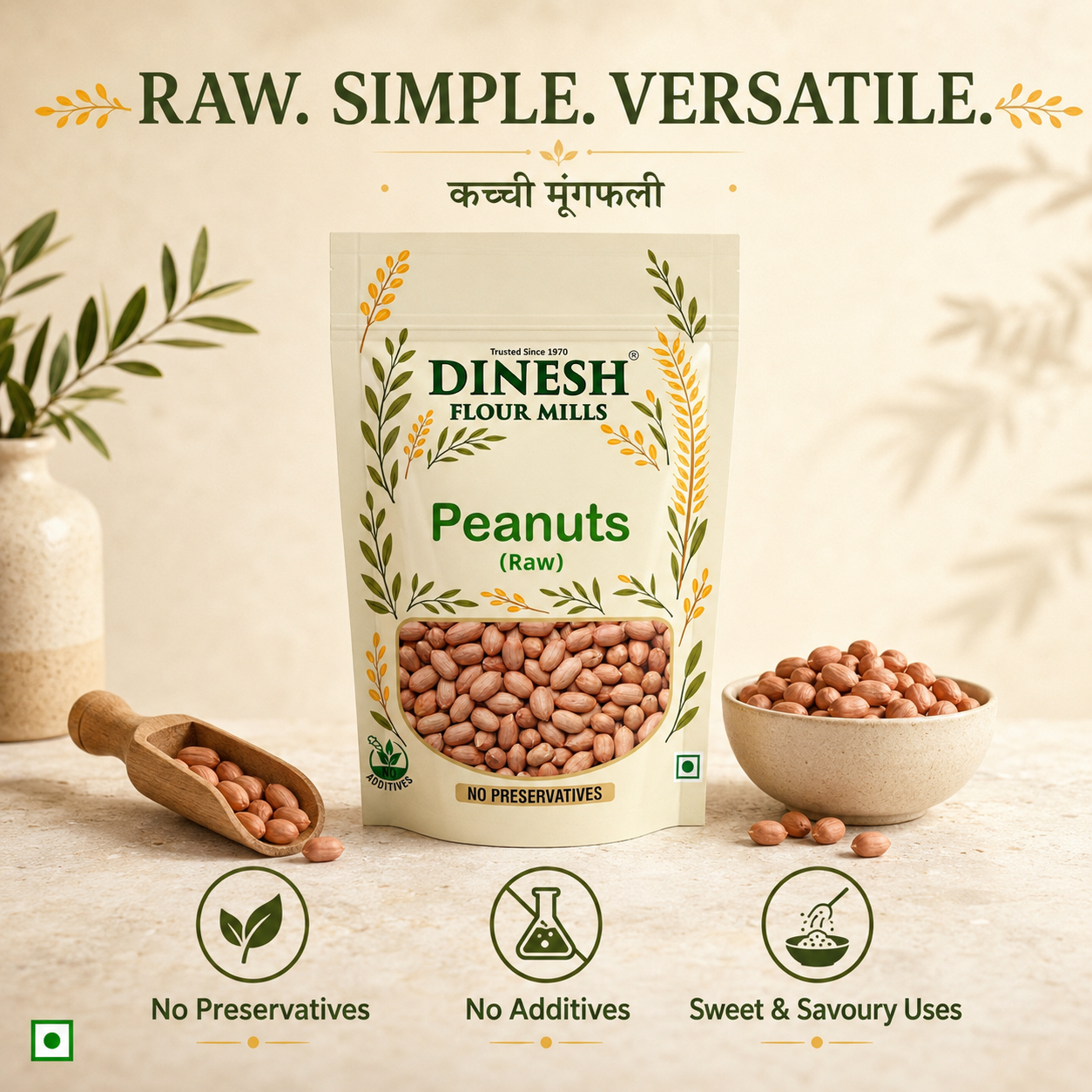A stand-up pouch of Dinesh Flour Mills Raw Peanuts centered on a light beige surface, with peanuts in a small wooden scoop and a bowl beside it. The package has green and gold text and wheat illustrations, and the image includes the headline 'RAW.